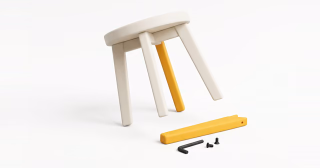 A small flat-pack stool being assembled with an Allen key